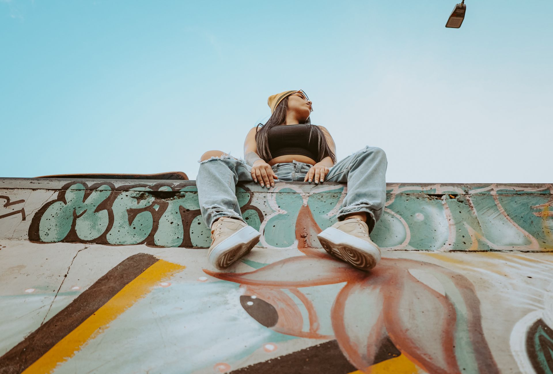 Woman posing on a graffiti wall