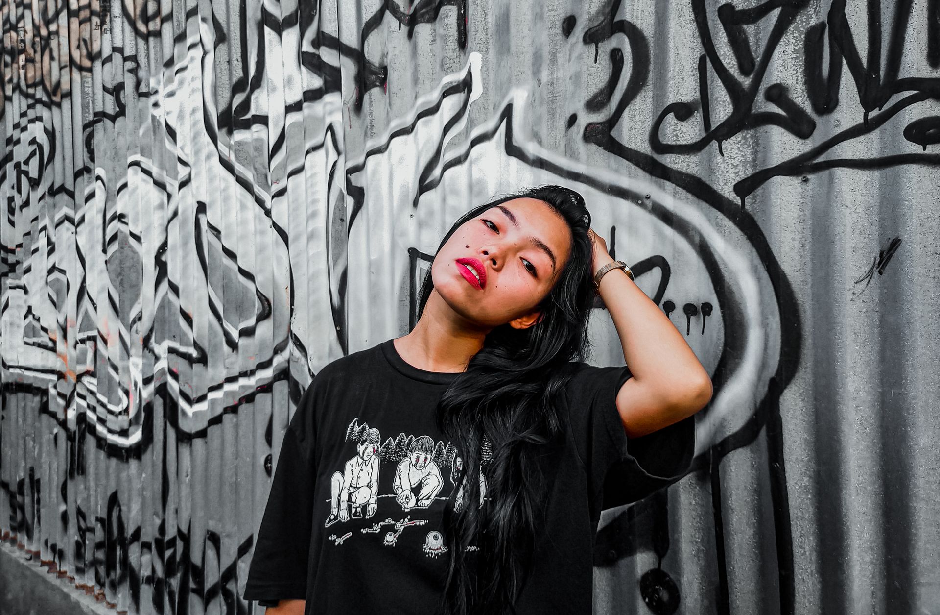 Woman beside a wall with graffiti